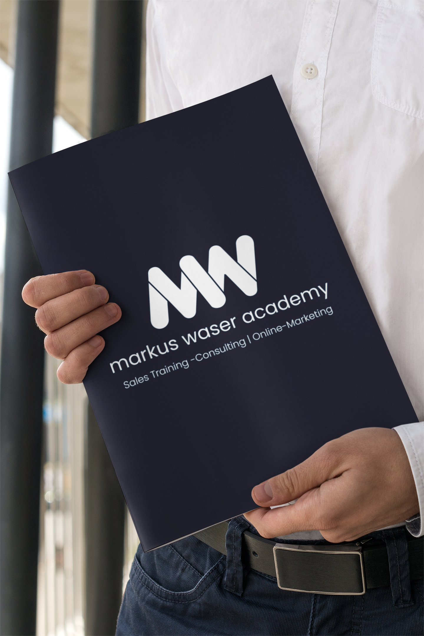 mockup-of-a-formal-man-holding-a-magazine-3388-el1